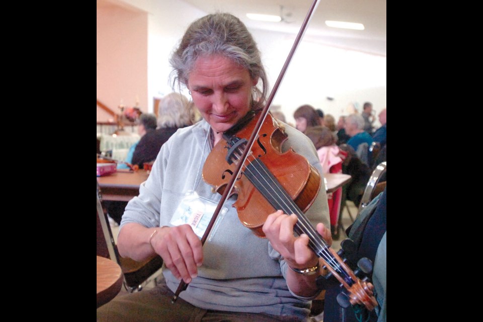 Marge Lachecke warms up before her set in the Prince George 45th annual Old Time Fiddling Contest.