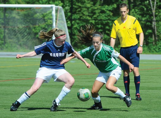 Sutherland's Anna Fox and Windsor's Sarah Pendreigh scramble for the ball in a zone playoff game Wednesday at Sutherland. Windsor won 1-0 to earn a trip to the provincial soccer AA championships.