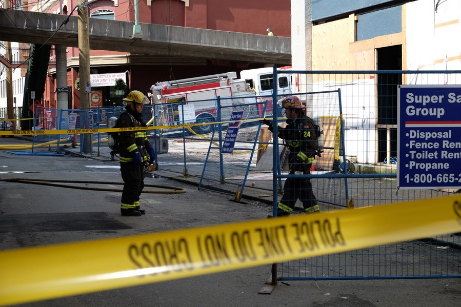 Back at the scene: New Westminster firefighters extinguished a small fire on Front Street on May 27, at a site that was involved in last year's massive fire on Columbia Street. Fire and police investigators believe the latest blaze is suspicious.