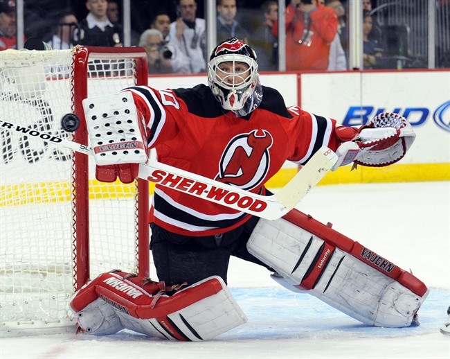 Goaltender Martin Brodeur stretches before practice as he tries to