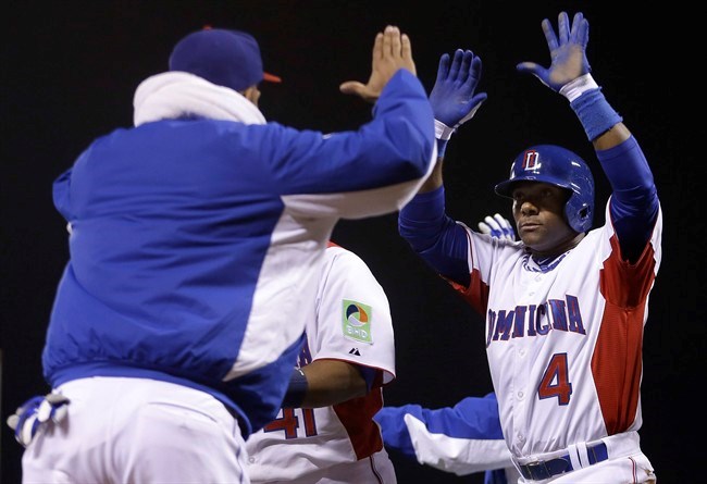 Dominican Republic's Jose Reyes, left, celebrates with teammate