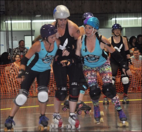 Roxie Shocker (left) and Sweetie Gonzalez team up to hit a member of the Doomsday Bunnies on Saturday (June 7).