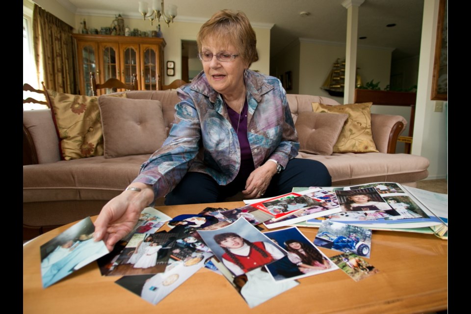 Linda Proctor examines photos of her granddaughter Kimberly, who was murdered in March 2010 by two teenage classmates.