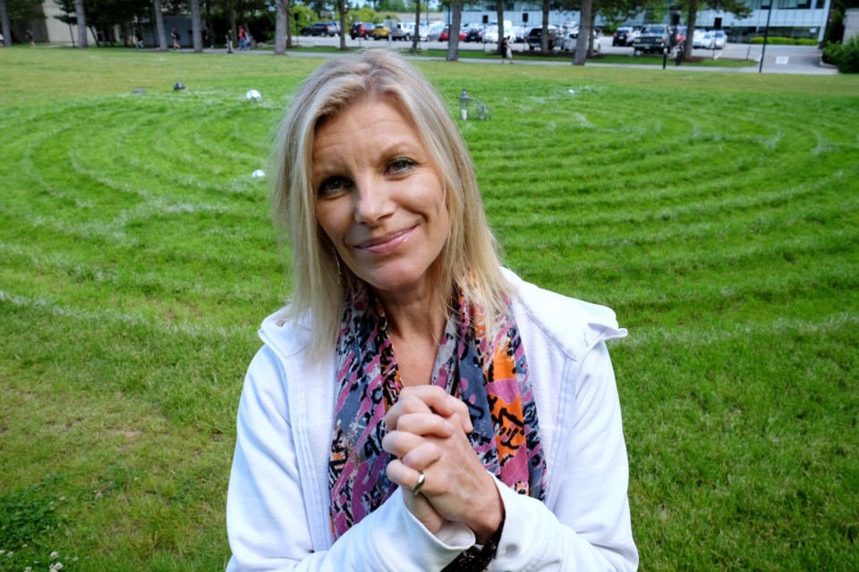 Ellen Vaillancourt with a yoga class at the peace labyrinth she created at SFU.