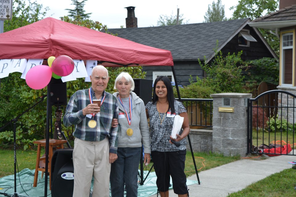 Burnaby resident Tessy Chalissery (at right) organized a block party in west Burnaby to help her neighbours get to know one another. These two received a medal for having lived in the neighbourhood the longest.