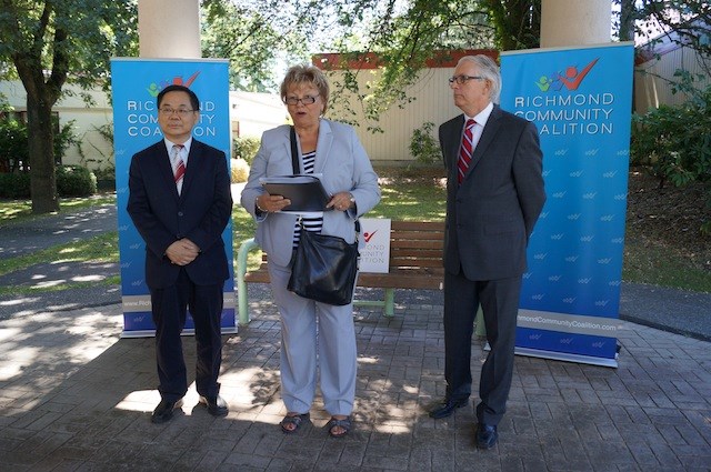 Sylvia Gwozd of the Richmond Community Coalition introduces candidates Ken Johnston and Chak Au. July, 2014.