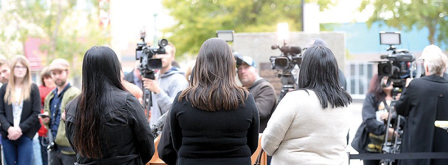 The victims' families speak to the media on the steps of the Prince George courthouse.