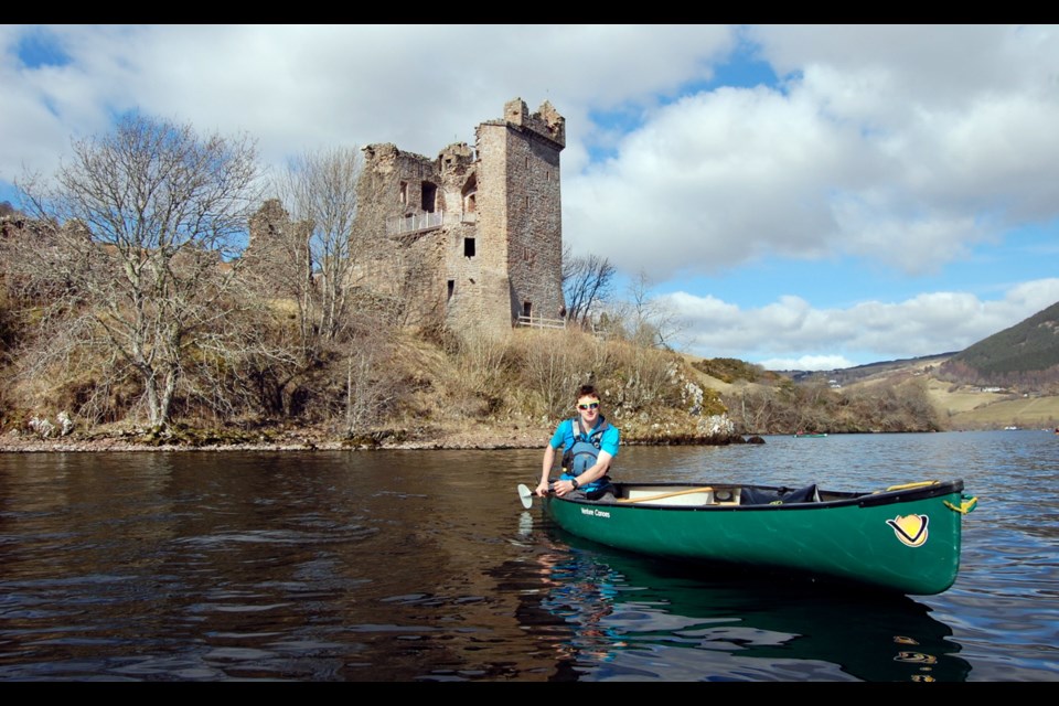 Dan Maggs, a guide from Boots N Paddles, leads a group on a canoe trip past Urquhart Castle on Loch Ness.