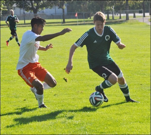 Quest's William Hoy dekes around a Langara defender during Pacwest soccer action on Sunday (Sept. 28).