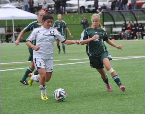 Quest's Gabriella Villasenor pushes the ball forward against a Royals defender during women's soccer action on Sunday (Oct. 12).