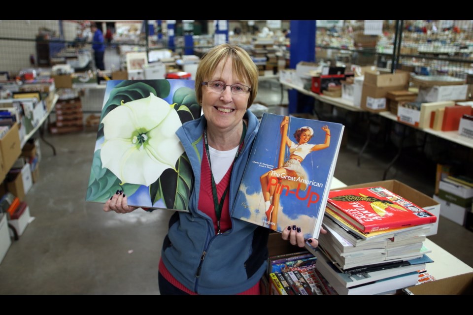 Wednesday: Donna Davis, who has been volunteering at the Times Colonist book sale for 16 years, showcases some of the books to be found.