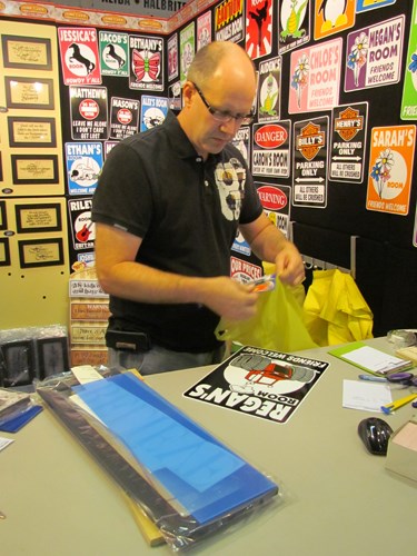 Randy Tremblay makes a custom sign for a customer. Saskatoon-based Pinetree Innovations is family owned and operated.