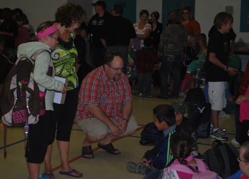 School councillor Jeff Laforet and Grade one teacher Lise Bechard Fuller speak with students before the first assembly of the new school year at Carlyle Elementary School.