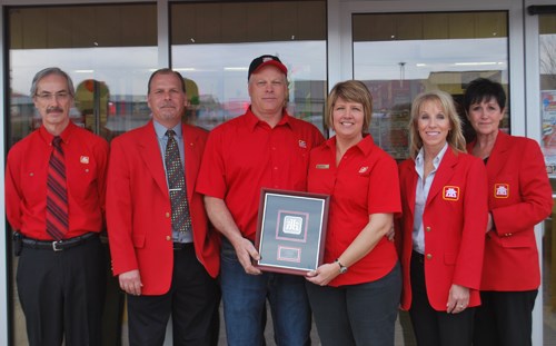 Nancy and Gilles Matthewson (center) pose with their Carlyle Home Hardware congratulatory plaque with Home Hardware representatives at their sides.