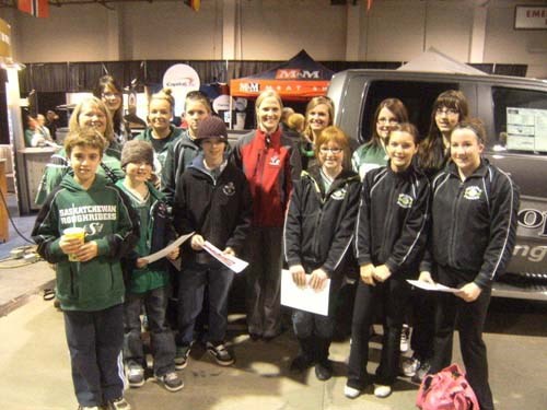 Carlyle G.F.K. students pose with World Championship silver medalist Amber Holland at the Ford World Curling Championships in Regina.