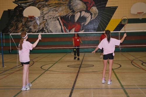 Carlyle and White Bear teams play during a girls double match.