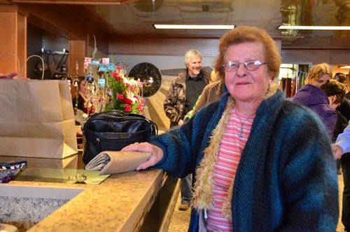 Mary Milligan of Arcola happily made the first purchase after the unveiling of one-twenty-two MAIN Fashion Boutique in Carlyle.