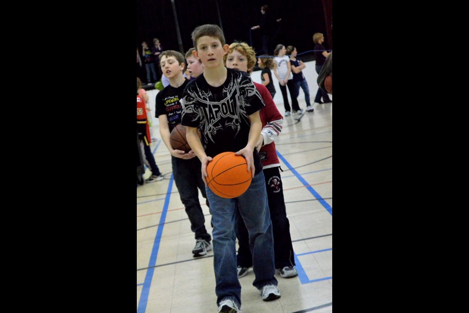 Halen Duhaime lined up to make a shot on the basket. He took turns with the boys lined up behind him.