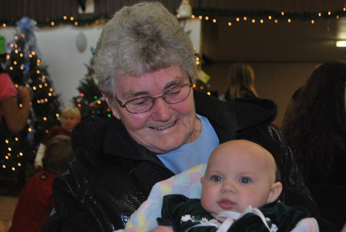 Marg Davis smiles down at one of the younger visitors to the Wawota Winter Festival, granddaughter Carlee Davis.