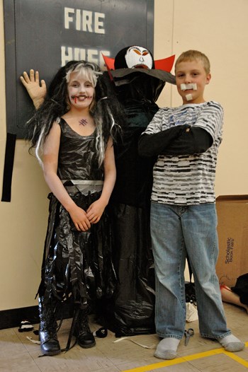 And the winner is....Mr. Jacula! Presley Onufreychuk, grade 5, and Willy Brimner, grade 6, show off the winning pumpkin.