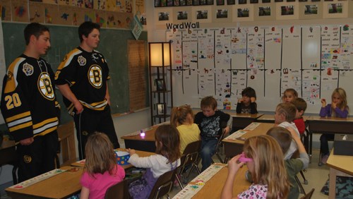 Local Ben Johnstone (left) and Captain Josh Jelinski (right) visit with Cheryl MacDonald&#8217;s grade one classroom on Nov. 1 as part of the Estevan Bruins school visits.