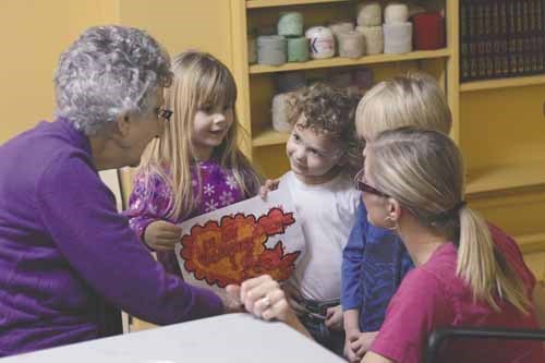 Yorkton Nursery School Cooperative kids show their valentines to teacher Karly Wagner and Gladstone Seniors Residence 
tenant Mary Derkatch. The nursery school children visited the seniors home on Monday and Tuesday to share cupcakes and color valentines for the residents.