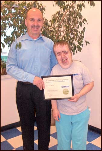 Donna Moore from the Yorkton SARCAN Depot, recently celebrated 20 years as a SARCAN employee. Presenting the award to Donna is Ray Saas. Donna received a watch and a plaque from Sask Abilities and a crystal light up ornament and plaque from SARCAN. Each year, SARCAN Recycling, a division of the Saskatchewan Association of Rehabilitation Centres (SARC), recognizes the commitment of its long-term employees at its Employee Recognition Day.  On October 27, 2011, employees from all over the province were invited to Travelodge Hotel in Regina. Service recognition is given to 5, 10, 15, and 20-year employees as well as retirees.  This year, 62 employees were acknowledged for their many years of service to the organization.  The event honours SARCAN&#8217;s long-term employees for contributing to the strength of SARCAN through their sense of teamwork and dedication.