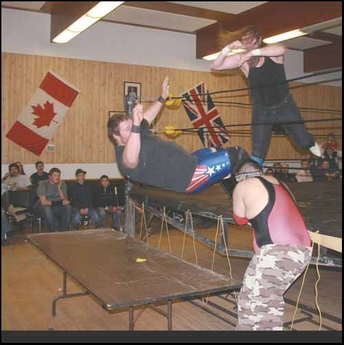 High Impact Wrestling was held Friday at the Royal Canadian Legion Hall in Yorkton. Here Rex Roberts, in ring, sends Bull Bodnar through a table with some help from Noah Man.HIW returns to the city Dec. 16