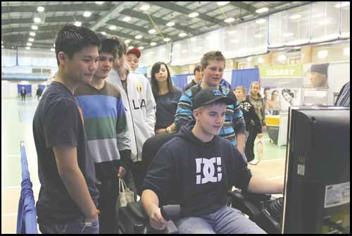 Lucas Peterson of Preeceville tries out a Parkland College Caterpillar M8 Grader simulator at Career Explorations 2011 on November 8. The second annual Parkland College/ Good Spirit School Division career fair featured more than 60 displayers and saw over 1,000 visitors through its doors. New this year was the addition of scheduled  sit-down presentations by the employers and educational institutions represented at the fair.