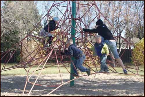 Thanksgiving weekend means summer has passed and fall too is winding down. The weekend is one of family, football, too much turkey and stuffing, and one more weekend to get outside and enjoy activities before the snow arrives. The weather this weekend was cool, but these kids bundled up and took full advantage of playground equipment in the city.