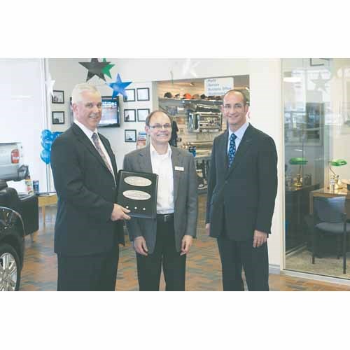 Ford Motor Company&#8217;s General Manager for Western Canada Gerald Wood (left) and Territory Sales Manager Delmar Giesbrecht (right) last week presented Terry Ortynsky with a plaque celebrating the 25th Anniversary of Terry Ortynsky&#8217;s Royal Ford. The dealership opened in Yorkton in September of 1985 and has enjoyed success ever since. To celebrate the milestone, Terry Ortynsky&#8217;s Royal Ford has spent the year making charitable donations to community programs and rewarding its longtime employees.