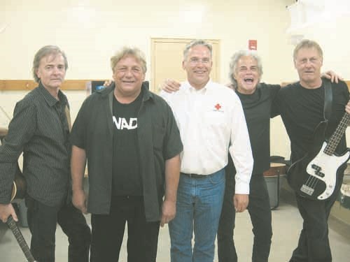 Michael Pasloski with the Canadian Red Cross is pictured with the members of Chilliwack before their concert at the Yorkton Exhibition.  100% of their CD sales ($1,400) were donated to help the Red Cross with the flood relief.