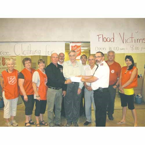 The Yorkton Lions have donated $10,000 to the Salvation Army to assist with the Yorkton Flood disaster. Pictured above (from left to right) are Lions president Allan Conkin, secretary Michael Liknaitzky, 3rd Vice President Peter Legebokoff and Major Henri Regamey along with all the volunteers at the Salvation Army Food Bank and Emergency Clothing Depot at the Parkland Mall.