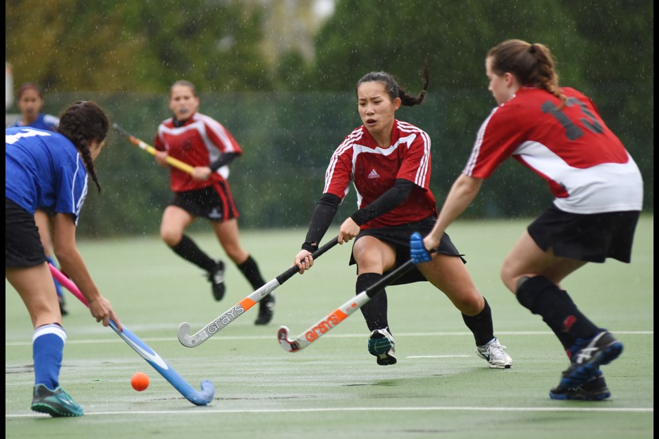 Magee Lions Angela Co and Ricky Muller (No. 13) reach for the ball in a 4-0 loss to Richmond’s McMath in the AAA zone championship final at Eric Hamber secondary on Oct. 30, 2014. Photo Dan Toulgoet