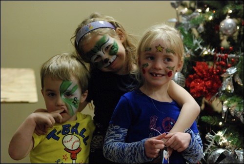 Keelan Smith, 3, Chloe Wilk, 6, and Taylor Smith, 4, showcase their face art by Twink-elle the Clown. There was plenty of entertainment for children, with gingerbread cookie decorating, crafts and a gift shop with donated items all set to wrap.