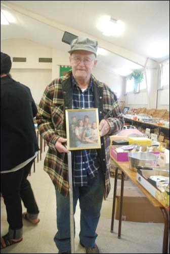 Frank Strong thought he&#8217;d find something interesting at St. Paul&#8217;s Anglican Church&#8217;s biannual rummage sale, but didn&#8217;t expect to see a photo of his family grinning back at him. &#8220;What a surprise,&#8221; said Strong, who rescued the photo. Since many church members often donate large boxes of &#8216;treasures&#8217; for the sale, it&#8217;s assumed the picture made it into the sale by accident. The sale represents a major fundraiser for the church.