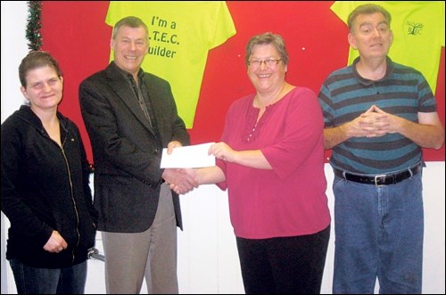 Jim Sutton of Cherry Insurance presents Ronda Johnson, office manager of Battlefords Trade and Education Centre, with a donation of $2,500 for BTEC's new building fund. Also in the picture are Tammy Anderson and Kim Lafreniere, BTEC participants.