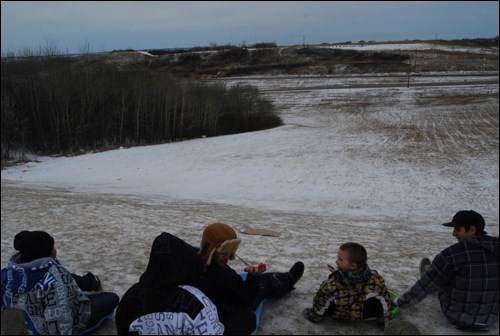 The snow is scarce but that doesn't stop thrill seekers from making trips down the hill behind Don Ross Centre.