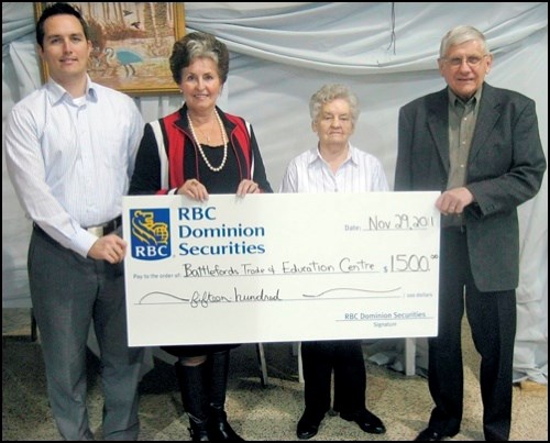 Jean Walker and Brendon Boothman of RBC Dominion Securities present a cheque from the RBC Foundation for $1,500 to Battlefords Trade and Education Centre board president Julian Stelmaschuk and vice-president Florance Krilow to go towards their building fund.