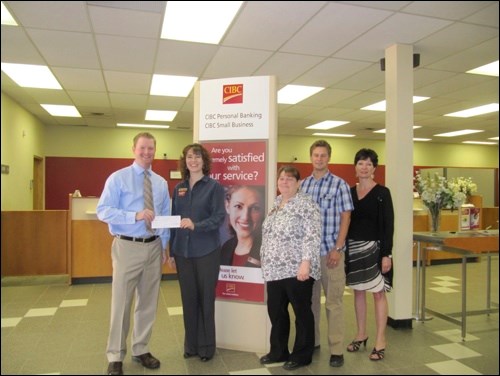 CIBC branch manager Evelyn Brown, second from left, and assistant branch manager Jamie Calder, third from left, presented a donation of $15,000 to three committee members of the CuPlex fundraising committee Thursday. The three members were Aaron Hermiston, far left, David Schell, second from right, and Darla Conley, far right.