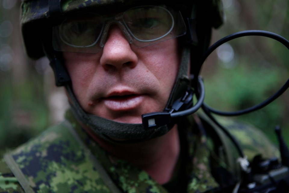 Sgt. Francois Horion communicates over his radio as he joins one hundred and fifty armoured members of the Canadian Army Royal 22nd Regiment from Valcartier, Quebec, taking part in the Trident Fury 13 military exercises at Albert Head Beach in Metchosin, B.C., Friday May 17, 2013. The biennial joint and multinational naval exercise, running from May 3 to 19, includes participation from the Royal Canadian Air Force, the Royal Canadian Navy, the Canadian Army, The United States Navy, U.S. Air Force, U.S. National Guard and U.S. Coast Guard members providing a full spectrum of air, land, and sea tactical warfare training with the aim of enhancing Canada's ability to respond to offshore threats and unlawful acts from within a coalition environment. THE CANADIAN PRESS/Chad Hipolito