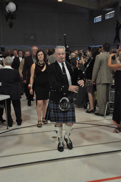 Jim Ramsay leads the honoured guests to the head table.