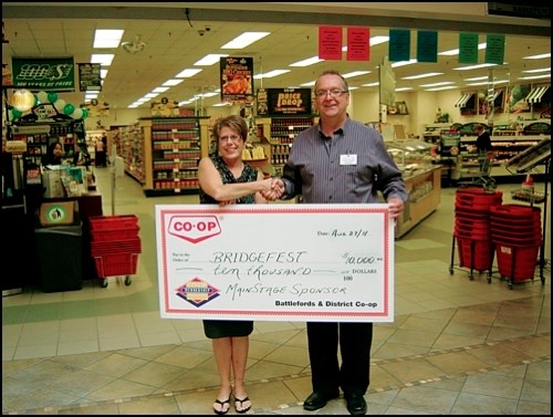 Bif Naked and an array of other talent will rock the main stage at this year&#8217;s BridgeFest, Aug. 27 at Battleford Flats, thanks to sponsorship from Battlefords and District Co-op. Bridgefest co-chair&#8232;Jane Zielke of Battlefords United Way accepts the $10,000 contribution from General Manager Pat Smith. &#8220;This donation shows the Co-op&#8217;s commitment to the event and support for the community,&#8221; Zielke said. She added that support from event sponsors shows what can happen if people work together.