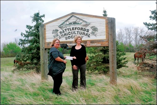 Battlefords Tribal Council is once again a major sponsor of the Canadian Professional Chuckwagon Races, handing over $10,000 to the Battlefords Agricultural Society for the third annual event. The chuckwagon races will be held May 27 to 29 at the Exhibition Grounds. Leah Milton (left), executive director of BTC, delivers the cheque to Jocelyn Ritchie, general manager of the BAS, May 18.