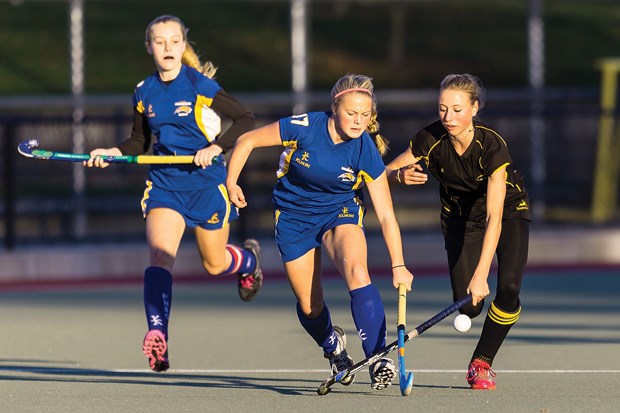 Handsworth's Anna Gosney jousts with a Shawnigan Lake player while teammate Sarah Walker looks on during the senior girls provincial AAA field hockey final played Friday at West Vancouver's Rutledge Field. Shawnigan claimed the title with a 4-0 win.