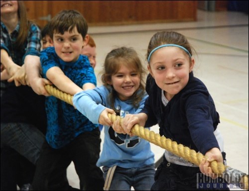 Members of the Blue Whales direct all their energy into pulling the rope in their battle against the Green Goblins in the tug-of-war event at the St. Dominic School Gym Blast held February 4.