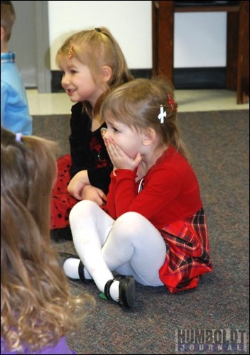 Megan Dyok covers her mouth and shivers during the song &#8220;Castle Crock,&#8221; performed by her class at the Humboldt Co-operative Preschool during their Christmas concert on December 15.