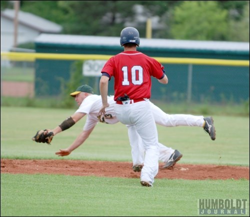 A Saskatoon Outlaws player scrambles for the ball as one of the Muenter Red Sox races to second base.