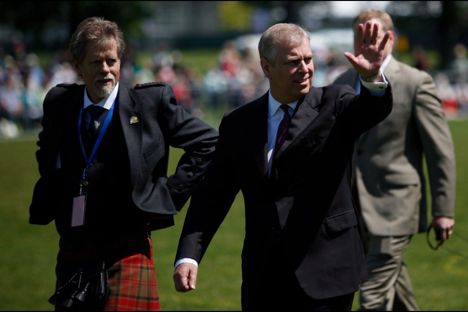 Prince Andrew, the Duke of York, waves to spectators during the 150th Victoria Highland Games Sunday at Topaz Park.