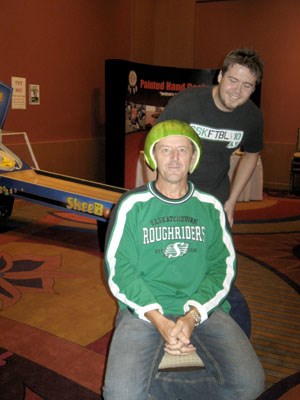 At the Yorkton Chamber of Commerce&#8217;s recently held 5:05 Club event, a raffle was held for the right to &#8220;crown&#8221; Yorkton Chamber of Commerce President Lawrence Wegner with a freshly carved watermelon helmet. Blair Maki (right), of Flashpoint Media was the lucky person selected to do the &#8220;crowning&#8221;. Wegner wore the helmet through the entire game between the Roughriders and BC Lions which he watched on the big screen at the Painted Hand Casino. As a result of the festivities, $100 was raised for Yorkton Minor Football.&#8194;